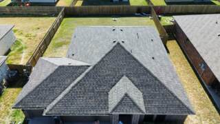 Aerial view of the front of the roof showing new IKO Dynasty shingles in Driftshake
