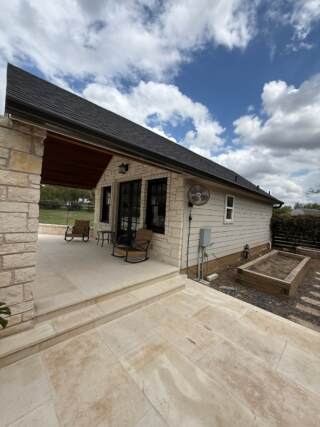 View of the right side of pool house showing new 6” seamless gutters in Dark Bronze