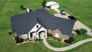 Aerial view of the front of the home showing new roof. Shingles are Pinnacle Atlas Class 4 in Shadow Black