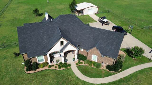 Aerial view of the front of the home showing new roof. Shingles are Pinnacle Atlas Class 4 in Shadow Black