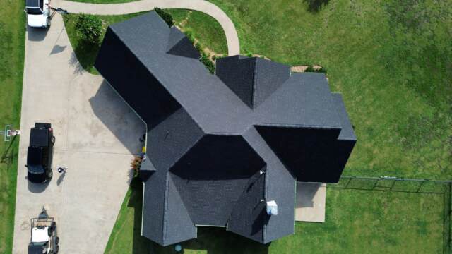 Aerial view of entire home showing new roof. Shingles are Pinnacle Atlas Class 4 in Shadow Black
