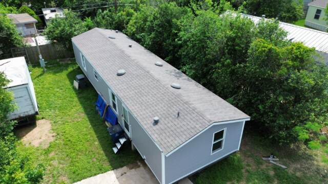 Aerial view of roof from an angle showing new IKO Cambridge shingles in Weatherwood