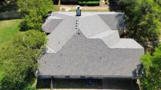 Aerial view of the left side of the roof showing new IKO Cambridge shingles in Weatherwood