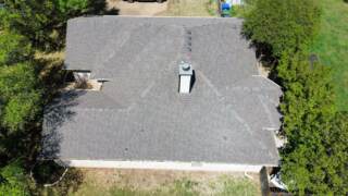 Aerial view of the right side of the roof showing new IKO Cambridge shingles in Weatherwood