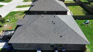 Aerial view of the right aide of the house showing new IKO Cambridge shingles in Driftwood