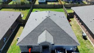 Aerial view of the front of the house showing new IKO Cambridge shingles in Driftwood