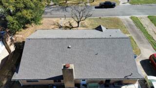 Aerial view of rear slope of roof showing new IKO Cambridge shingles in Weatherwood