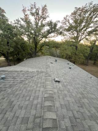 View of the whole roof looking down main ridge of the roof with new 30 year Architectural shingles. Shingles are IKO Cambridge in Weatherwood