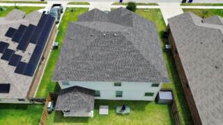 Aerial view showing back of the home with new 30 year Class 3 Architectural shingles. Shingles are IKO Dynasty in Driftwood