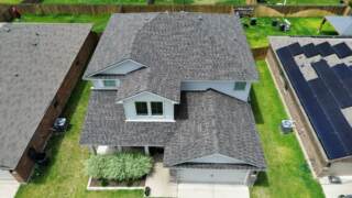 Aerial view showing front of the home with new 30 year Class 3 Architectural shingles. Shingles are IKO Dynasty in Driftwood