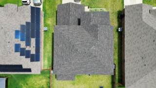 Aerial view directly overhead of the home with new 30 year Class 3 Architectural shingles. Shingles are IKO Dynasty in Driftwood