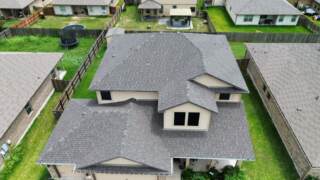 Aerial view of the front of the home showing new 30 year Architectural shingles. Shingles are IKO Cambridge in Driftwood