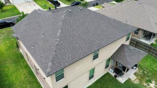 Aerial view of the right rear of the home showing new 30 year Architectural shingles. Shingles are IKO Cambridge in Driftwood