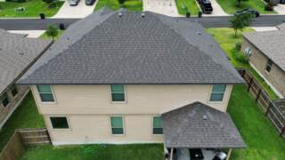 Aerial view of the back of the home showing new 30 year Architectural shingles. Shingles are IKO Cambridge in Driftwood