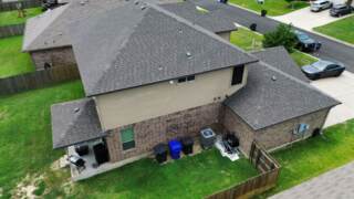Aerial view of the left side of the home showing new 30 year Architectural shingles. Shingles are IKO Cambridge in Driftwood