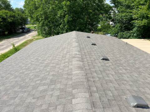 view from right side looking down the ridge showing the new shingles. Shingles are IKO Cambridge in Weatherwood
