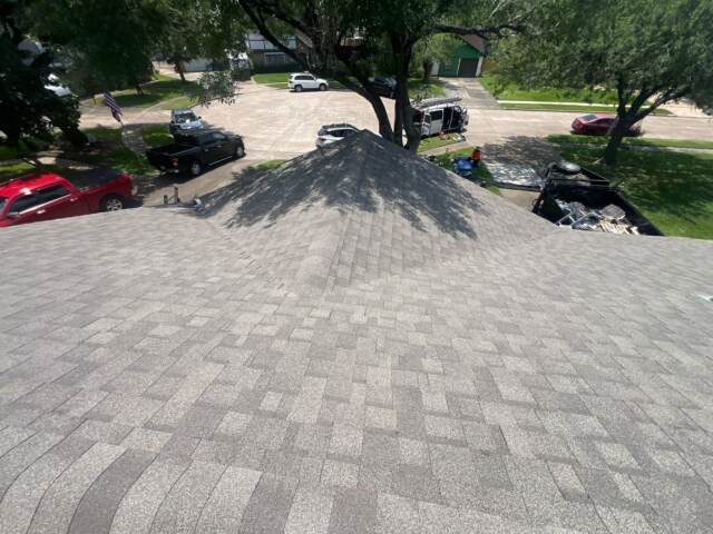 View of the front slope of the roof showing new shingles. Shingles are IKO Cambridge in Weatherwood