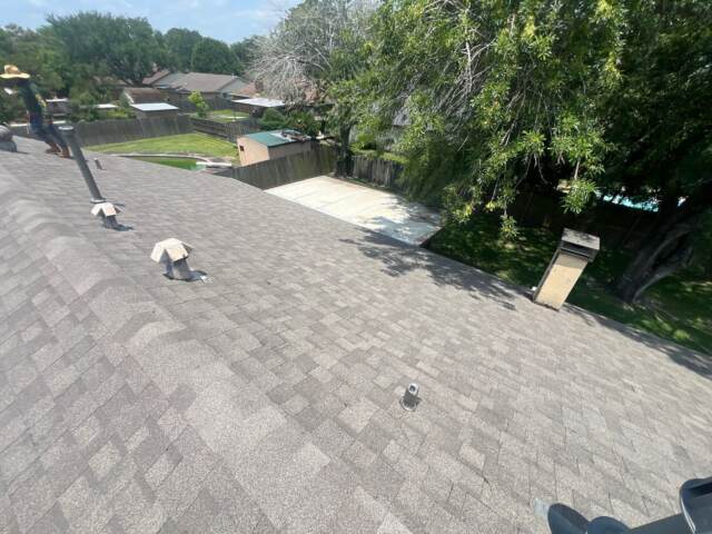 View of the back slope of the roof showing new shingles. Shingles are IKO Cambridge in Weatherwood