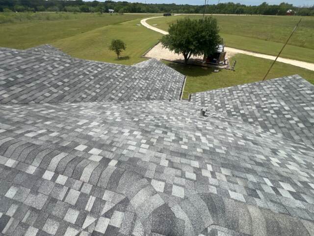 View of the front slope of the roof showing new shingles. Shingles are IKO Dynasty in Castle Grey