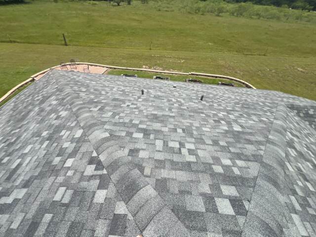 View of the right slope of the roof showing new shingles. Shingles are IKO Dynasty in Castle Grey