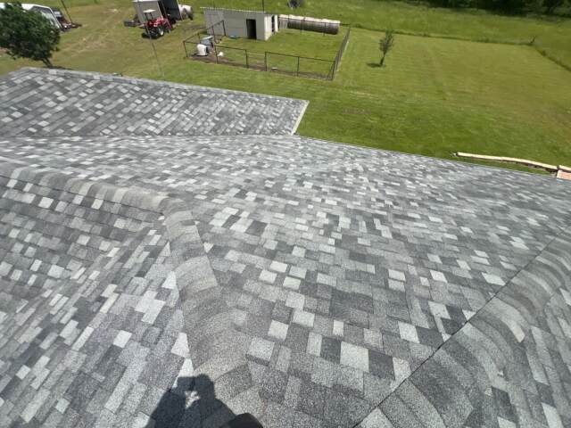 View of the rear slope of the roof showing new shingles. Shingles are IKO Dynasty in Castle Grey