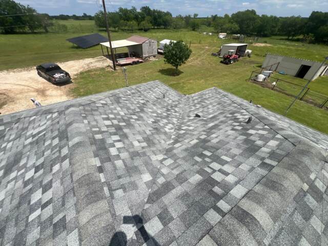 View of the left slope of the roof showing new shingles. Shingles are IKO Dynasty in Castle Grey