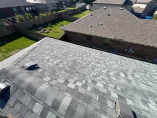 View of the right side of the roof showing the new 30 year Class 4 Architectural shingles. Shingles are IKO Nordic in Castle Grey