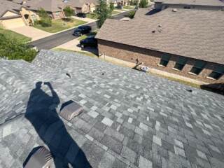 View of the left side of the roof showing the new 30 year Class 4 Architectural shingles. Shingles are IKO Nordic in Castle Grey