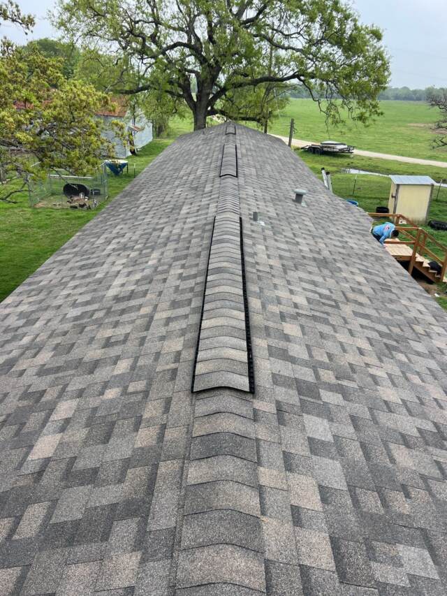 View of new roof looking down the ridge from the left side. Shingles are IKO Dynasty in Driftshake