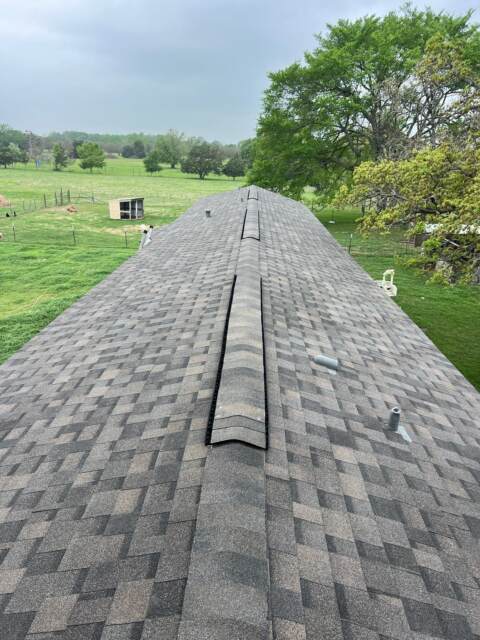 View of new roof looking down the ridge from the right side. Shingles are IKO Dynasty in Driftshake