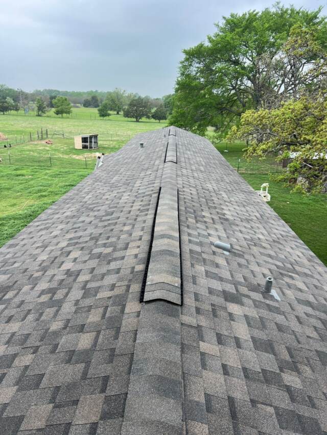 View of new roof looking down the ridge from the right side. Shingles are IKO Dynasty in Driftshake