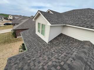 View from the roof of the front slopes with new 30 year Class 3 Architectural shingles. Shingles are IKO Dynasty in Driftshake