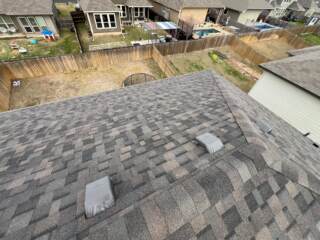 View from the roof of the back slope with new 30 year Class 3 Architectural shingles. Shingles are IKO Dynasty in Driftshake