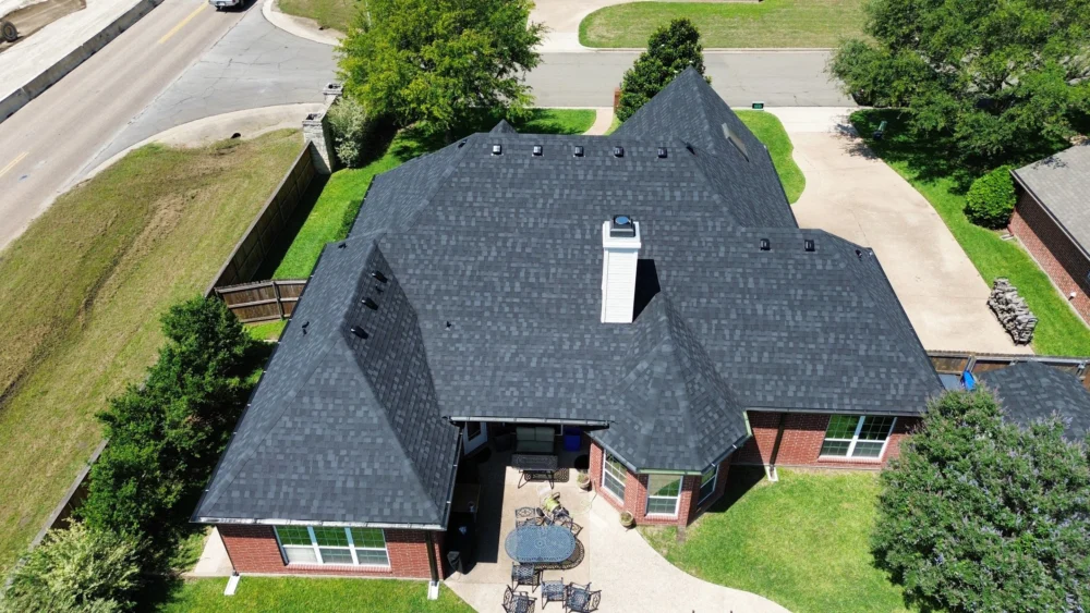 Rear view of the roof showing new architectural shingles by IKO in Granite Black