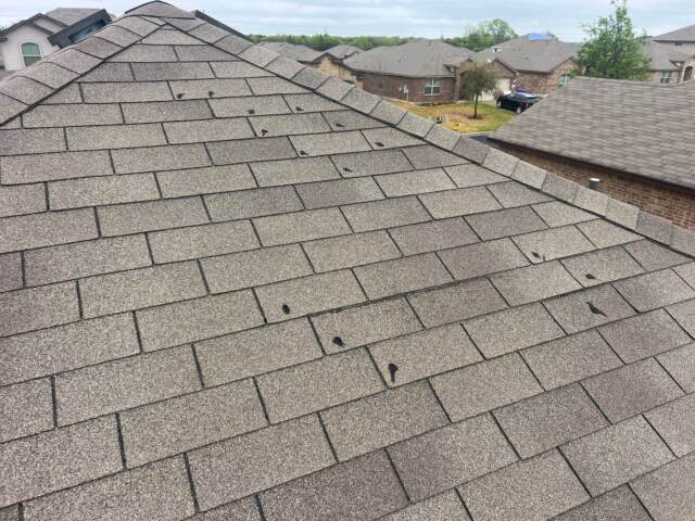 Original roof - wind damaged shingles nailed down by customer